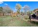 Fenced backyard featuring a swing set, spacious deck, and a grassy area perfect for and outdoor activities at 2009 S Zephyr Ct, Lakewood, CO 80227