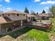 Spacious backyard featuring a deck, patio, and lush green lawn, creating an ideal space for outdoor living and entertainment at 2009 S Zephyr Ct, Lakewood, CO 80227