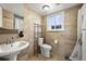 Finished bathroom featuring neutral-colored tile throughout, a modern toilet, and a vanity sink at 2009 S Zephyr Ct, Lakewood, CO 80227