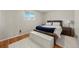 Cozy bedroom featuring wood floors, neutral walls, and natural light at 2009 S Zephyr Ct, Lakewood, CO 80227