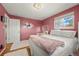 Bedroom featuring wooden floors, neutral walls, natural light, and stylish furnishings at 2009 S Zephyr Ct, Lakewood, CO 80227