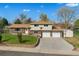 Charming two-story home featuring brick accents, a well-maintained lawn, a two car garage and a welcoming facade at 2009 S Zephyr Ct, Lakewood, CO 80227