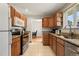 Well-maintained kitchen with stainless steel appliances, tile flooring, and granite countertops at 2009 S Zephyr Ct, Lakewood, CO 80227