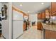 Spacious kitchen with wooden cabinets, granite countertops, stainless steel appliances and tile floors at 2009 S Zephyr Ct, Lakewood, CO 80227