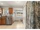 Bright kitchen area features tile floor, stainless steel appliances, a window, and storage at 2009 S Zephyr Ct, Lakewood, CO 80227