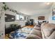 Comfortable living area with a large window, modern furniture, hardwood floors, and ample natural light at 2009 S Zephyr Ct, Lakewood, CO 80227