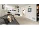 Finished basement living room with neutral carpet, a ceiling fan, and walkout access at 2009 S Zephyr Ct, Lakewood, CO 80227