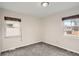 Well-lit bedroom featuring gray carpeting and dual windows at 4981 E Cornell Ave, Denver, CO 80222