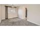 Simple dining area with gray carpet and a window with blinds at 4981 E Cornell Ave, Denver, CO 80222