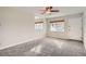 Bright and airy living room with gray carpeting and a ceiling fan at 4981 E Cornell Ave, Denver, CO 80222