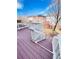 Wooden deck with white railings, offering stairs down to the grassy backyard, creating a cozy outdoor space at 26032 E Geddes Cir, Aurora, CO 80016