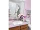 Bathroom vanity featuring a decorative counter, and a mirror reflecting a shower and toilet at 26032 E Geddes Cir, Aurora, CO 80016