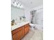 Bathroom with a vanity, large mirror, toilet, and shower with floral curtain at 26032 E Geddes Cir, Aurora, CO 80016