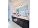 Bathroom featuring double sinks with dark wood cabinets at 26032 E Geddes Cir, Aurora, CO 80016