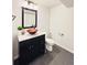 Powder room featuring a black vanity with a unique orange vessel sink and dark gray tile flooring at 26032 E Geddes Cir, Aurora, CO 80016