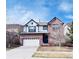 Charming two-story brick home with a well-maintained lawn and a two-car garage at 26032 E Geddes Cir, Aurora, CO 80016