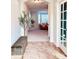Welcoming foyer with tile flooring, a decorative bench, and an arched doorway leading to the living room at 26032 E Geddes Cir, Aurora, CO 80016