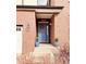 Inviting home entrance with a blue front door, decorative wreath, and potted plants at 26032 E Geddes Cir, Aurora, CO 80016
