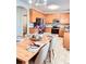 Spacious kitchen with wooden cabinets and a dining table set for a meal at 26032 E Geddes Cir, Aurora, CO 80016