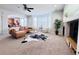 Inviting living room with stylish leather sofa, bay windows, fireplace, and open layout at 26032 E Geddes Cir, Aurora, CO 80016