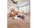 Open-concept living room with a cozy leather couch and views into the kitchen at 26032 E Geddes Cir, Aurora, CO 80016