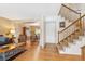 Home entryway with hardwood floors, staircase, and views into the living and dining rooms at 15771 W 64Th Pl, Arvada, CO 80007