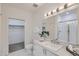 Modern bathroom with walk-in shower, white subway tile, white cabinets and countertop, and mosaic tile flooring at 3500 S Corona St # 407, Englewood, CO 80113