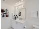 Bright bathroom with sleek vanity, modern fixtures, floating mirror, and decorative art, complemented by mosaic tile at 3500 S Corona St # 407, Englewood, CO 80113