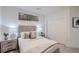 Serene bedroom featuring accent lamps, neutral tones, sliding closet doors and textured glass block window for privacy at 3500 S Corona St # 407, Englewood, CO 80113