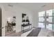 Sunlit bedroom with a large window, desk and chair, and open doorway to a living space with a modern aesthetic at 3500 S Corona St # 407, Englewood, CO 80113