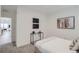 Relaxing bedroom with a console table, textured throw blanket, accent paintings and doorway into a common area at 3500 S Corona St # 407, Englewood, CO 80113