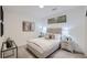 Calm bedroom featuring neutral tones, plush bedding, accent lamps, and artwork, creating a cozy and inviting atmosphere at 3500 S Corona St # 407, Englewood, CO 80113