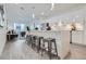 Open concept kitchen with stainless steel appliances, an island with bar seating and flows into living area at 3500 S Corona St # 407, Englewood, CO 80113