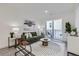 Bright living room featuring modern furnishings, stylish rug, and access to private balcony at 3500 S Corona St # 407, Englewood, CO 80113