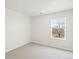 This bedroom has a window with a view of a bare tree and houses nearby at 1937 S Coolidge Way, Aurora, CO 80018