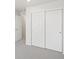 This bedroom features neutral walls and carpet and a large closet with sliding doors at 1937 S Coolidge Way, Aurora, CO 80018