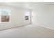 This bedroom has two windows with a view of the nearby trees and houses at 1937 S Coolidge Way, Aurora, CO 80018