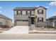 Charming two-story home with stone accents, a spacious two-car garage, and a well-manicured front yard at 1937 S Coolidge Way, Aurora, CO 80018