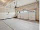 Spacious two-car garage featuring a concrete floor and an automatic door at 1937 S Coolidge Way, Aurora, CO 80018