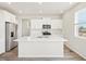 Stylish kitchen features white cabinets, stainless steel appliances, and a large island, perfect for culinary enthusiasts at 1937 S Coolidge Way, Aurora, CO 80018