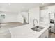 Beautiful kitchen featuring a stainless steel sink, quartz countertops, and an open floor plan, great for entertaining at 1937 S Coolidge Way, Aurora, CO 80018