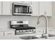Bright kitchen features stainless steel appliances and subway tile backsplash at 1937 S Coolidge Way, Aurora, CO 80018