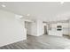 Open-concept living room with hardwood floors flows into a modern kitchen, ideal for entertaining and Gathering time at 1937 S Coolidge Way, Aurora, CO 80018