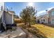 View of the backyard with patio, landscaping, and mature trees at 5830 Ceylon St # B, Denver, CO 80249