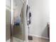 Tiled shower with glass door in bathroom with striped towel at 5830 Ceylon St # B, Denver, CO 80249