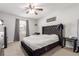 Comfortable bedroom with a ceiling fan and a tufted headboard at 5830 Ceylon St # B, Denver, CO 80249
