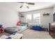 bedroom featuring large windows, carpet floors, and playful decor at 5830 Ceylon St # B, Denver, CO 80249