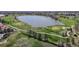 Scenic aerial view of a golf course with a lake, trees, and well-manicured greens at 7700 W Grant Ranch Blvd # 4A, Littleton, CO 80123