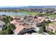 A scenic aerial view of a residential neighborhood with tree-lined streets near a tranquil lake at 7700 W Grant Ranch Blvd # 4A, Littleton, CO 80123