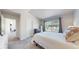 Spacious bedroom boasts a queen-sized bed, gray carpet and a large window providing natural light at 7700 W Grant Ranch Blvd # 4A, Littleton, CO 80123